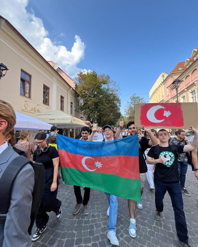 Students carrying the Azerbaijani flag through Vilnius old town during the university parade